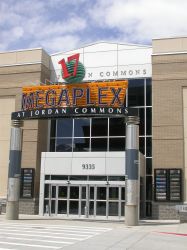The east entrance of the Megaplex 17 at Jordan Commons has a neon sign that sits atop two pillars. - , Utah
