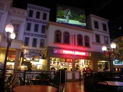 Above the Cinema Snacks shop is a large screen showing commercials and previews of movies. - , Utah
