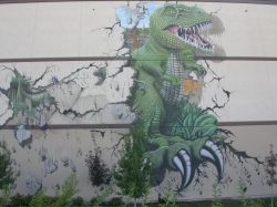 A mural depicting a dinosaur escaping the 3D movie by breaking through the northwest wall of the theater. - , Utah