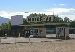 The three main ticket booths of the Motor-Vu Drive-In.  Behind them on the left is Screen 2.