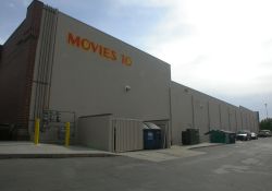The Movies 10 name is painted on the north exterior wall of Theater 6.  Theater 6 was an addition to an existing building.  On the left is a walkway to the front of the building. - , Utah
