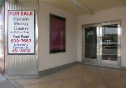 The left side of the Murray Theatre entrance has two poster cases and a set of double doors. - , Utah