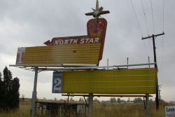 The sign of the North Star Drive-In has a large star at its top with two large attractions boards beneath.  Above the name of the theater on the sign, 'North Star' is the word 'Twin'. - , Utah