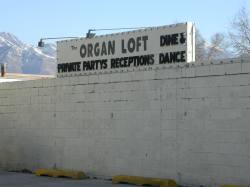 A sign for The Organ Loft on the side of the building facing 3300 South.  In addition to silent movies, the Organ Loft does 'Private Partys, Receptions, Dine & Dance.' - , Utah