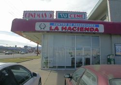 Above one of the stores are signs for Cinemas 5 and Tu Cine. - , Utah
