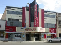 The front of the Price Theater.  There are shops on either side of the theater entrance. - , Utah