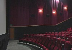 A panorama view of one of the larger auditoriums at the Redstone 8 Cinemas, from theater's large 40-foot movie screen to the back of the stadium seating section. - , Utah