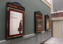On the left are three poster cases and on the right is an exit from the Redstone Cinemas. - , Utah