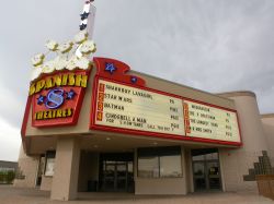 The theater has a triangular marquee with the name of the theater on the front and an attraction board on each side.  Underneath are two ticket booths with two ticket windows each. - , Utah