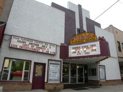 The theater has a triangular marquee over the entrance and a separate attraction board over the shop on the left side. - , Utah