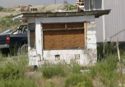 The windows of the ticket booth are now boarded up.  A trailer sits beside it. - , Utah