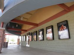 Poster cases line the wall beneath the theater's circular marquee. - , Utah