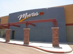On the east wall of the building is a 'Movies' sign on a blue background. - , Utah