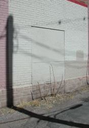 A boarded up exit, midway along the west wall of the theater. - , Utah