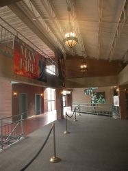 The lobby outside Trolley Corners Theater 1 was open to the level above.  The concession stand and entrances to the auditorium are on the right.  The stairs on the left lead down to the ticket booth on the level below. - , Utah