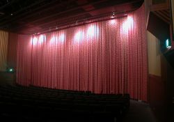 Red curtains covered the curved screen in Trolley Corners Theater 1.  When the movie began the curtains rose upwards and the eight doors into the auditorium magically closed by themselves. - , Utah