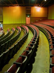 Curved rows of red seats in the back section of Trolley Corners Theater 1. - , Utah