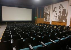 Looking towards the screen and north wall of Theater 3.  The screen has no curtain and is mounted on the back wall of the auditorium.