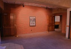 Between the entrance doors to Theater 2 is a single poster case on a brick wall. - , Utah