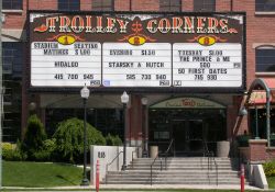 The sign for the Trolley Corners Theatres from across the street.  Below the sign on the right is an entrance to the building.  The area on the left of the entrance was originally a driveway to the parking structure and bank drive-thru. - , Utah