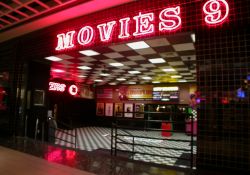 Above the entrance is the name of the theater, 'Movies 9', written in neon. - , Utah