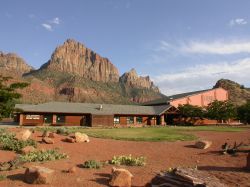 Grass and desert landscaping in front of the Zion Canyon Theatre.  The theater is on the left.  On the right are some shops and courtyard. - , Utah